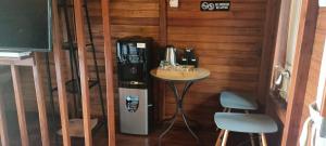 a room with a coffee machine and a table and two stools at Villa Kayu Unique with private pool in Babagan