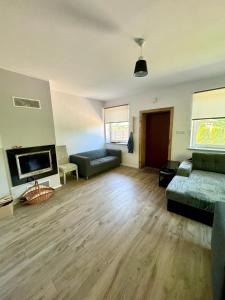 a living room with a couch and a fireplace at Corner House Plesna in Pleśna +37 photos