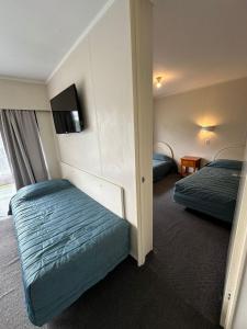 Ein Bett oder Betten in einem Zimmer der Unterkunft Airport Gold Star Motel