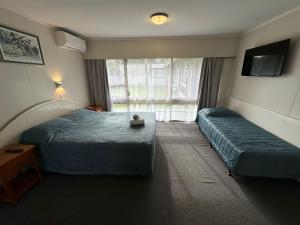 Ein Bett oder Betten in einem Zimmer der Unterkunft Airport Gold Star Motel