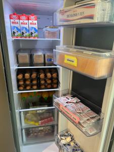 an open refrigerator filled with lots of food and eggs at Solo Stay Myeongdong in Seoul