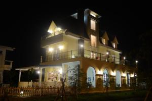 a large building with a balcony at night at Brulee's Done in Dongshan