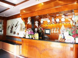 a restaurant with a counter with christmas decorations at Hotel Menara Lexus in Polonia Airport
