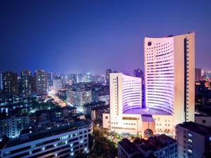 a city skyline at night with tall buildings at Xiamen Jingmin Central Hotel in Xiamen