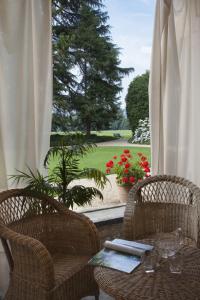 a table and chairs with a view of a garden at Agriturismo Il Torrione in Pinerolo