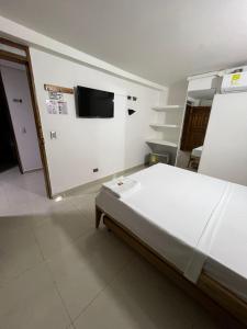 Postel nebo postele na pokoji v ubytování ApartaHotel Los Naranjos
