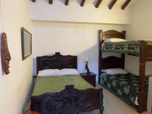 a bedroom with two bunk beds in a room at Casa Boyero de Berna Campestre in Villa de Leyva
