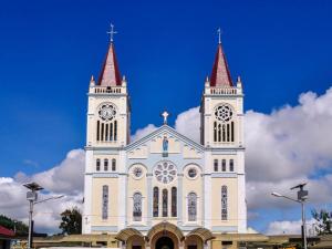 a large white church with a clock tower at Hotel Veniz in Baguio