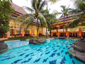a large swimming pool in front of a building at The Arnawa Hotel in Pangandaran
