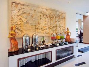 a room with a wall with a carving on it at The Arnawa Hotel in Pangandaran