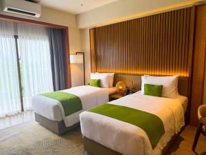 Voodi või voodid majutusasutuse Cebu One Tectona Resort Hotel toas