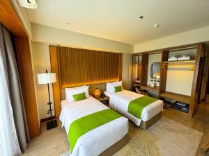 Voodi või voodid majutusasutuse Cebu One Tectona Resort Hotel toas
