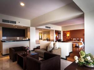 a living room with a couch and a table at CLARO Makassar Hotel & Convention in Makassar