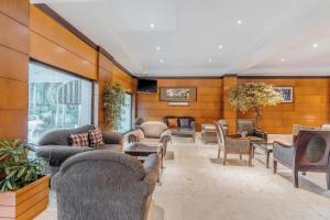 a lobby with couches and chairs and a table at Sriwijaya Hotel in Jakarta