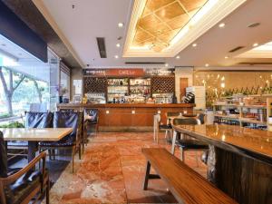 a restaurant with tables and chairs and a bar at New Pearl River Hotel in Guangzhou