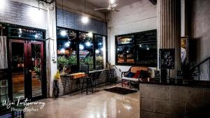 a restaurant with a bar with a table and chairs at Chinawat Hotel in Sukhothai