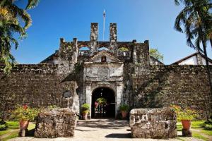 an old stone building with a large doorway at Express Inn Cebu Mabolo in Dita