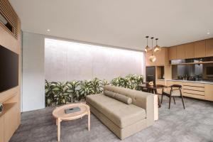 a living room with a couch and a table at INSPIRA Seminyak in Seminyak
