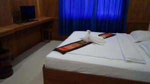 Postel nebo postele na pokoji v ubytování Lankham Hotel