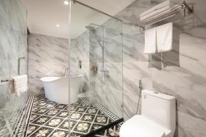 a bathroom with a shower and a toilet and a sink at Acoustic Premium Hotel & Spa in Hanoi +36 photos