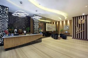 a lobby of a hotel with a reception desk at Golden Tulip Galaxy Hotel Banjarmasin in Benuaanyar +135 photos