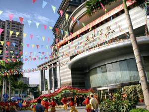 a crowd of people walking in front of a building at Nanning Yongjiang Hotel in Nanning