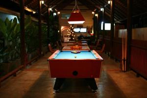 a ping pong table in a room with a ping pong ball at Lotusland Resort in Jomtien Beach