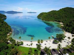 an aerial view of a beach with palm trees and blue water at Secret Paradise Resort & Turtle Sanctuary in San Vicente