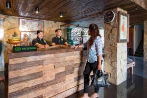 a woman standing in front of a bar at Hadi Poetra Hotel in Kuta +190 photos