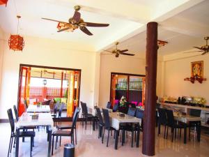 a dining room with tables and chairs and a ceiling fan at Donut Resort in Ban Dong +254 photos