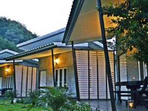 a house with wooden shutters on the side of it at V Valley Resort in Satun
