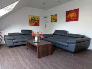 a living room with two couches and a coffee table at Exclusive Apartment - Rees in Rees