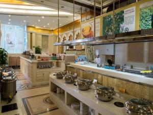 a kitchen with many pots and pans on a counter at Vienna International Hotel Shenzhen North Station Branch in Shenzhen