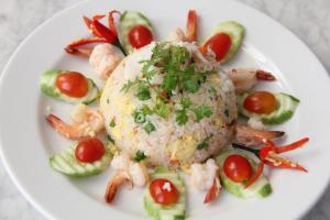 a plate of food with shrimp and rice and vegetables at The Mou Hotel in Phnom Penh