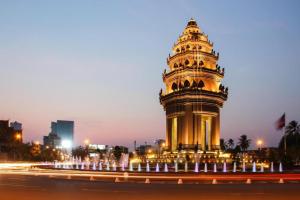 a clock tower in a city at night at The Mou Hotel in Phnom Penh