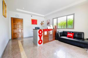 a living room with a couch and a counter at OYO 732 Juthamas Hotel in Patong Beach