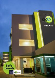 a building with a sign that reads safe travels at IXO Bekasi in Bekasi