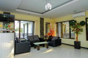 a lobby with couches and a table in a building at Capital O 887 Green Hill Hotel And Convention Center in Jember