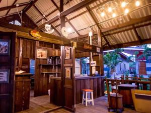 a large room with a bar and a restaurant at Baan Pran Boutique Resort in Hua Hin