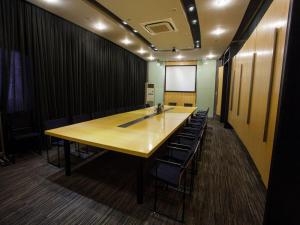 a conference room with a long table and chairs at Jinjiang Inn Shanghai Tongji University in Shanghai
