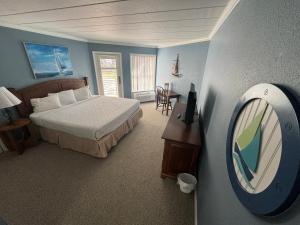 a bedroom with a bed and a mirror and a table at Marina Bay Resort in Fort Walton Beach +37 photos