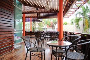 a patio with tables and chairs on a porch at GreenView Boutique Hotel in Sungai Kolok