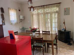 a dining room with a wooden table and chairs at Araliya Home Stay in Kandy