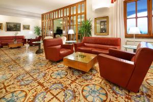 a living room with couches and a table at Hotel Parco Smeraldo Terme in Ischia