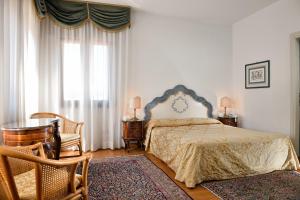 a bedroom with a bed and a chair at San Marco Palace in Venice