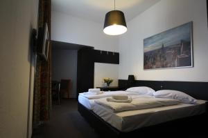 a bedroom with two beds with white sheets and pillows at Carlton Hotel in Frankfurt/Main +67 photos