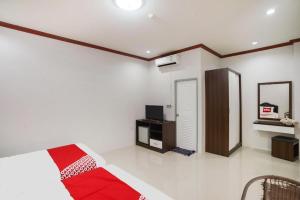 a bedroom with a bed and a television in it at OYO 75394 Sakthong Grand Hotel in Chiang Khong