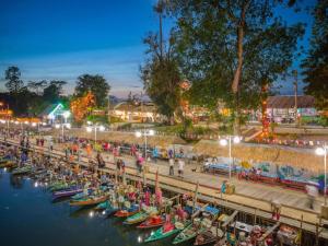 a row of boats in the water at night at WE Hostel Hatyai in Hat Yai