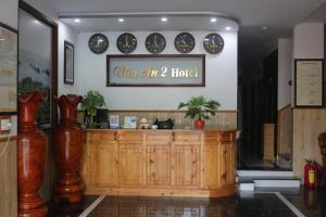 a restaurant with a counter and plates on the wall at Van An 2 Hotel in Phước Hậu