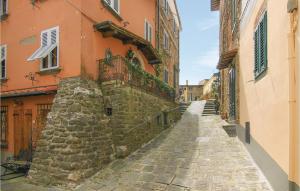 an alley in an old building with a stone wall at Stunning Home In Montecatini Alto in Nievole